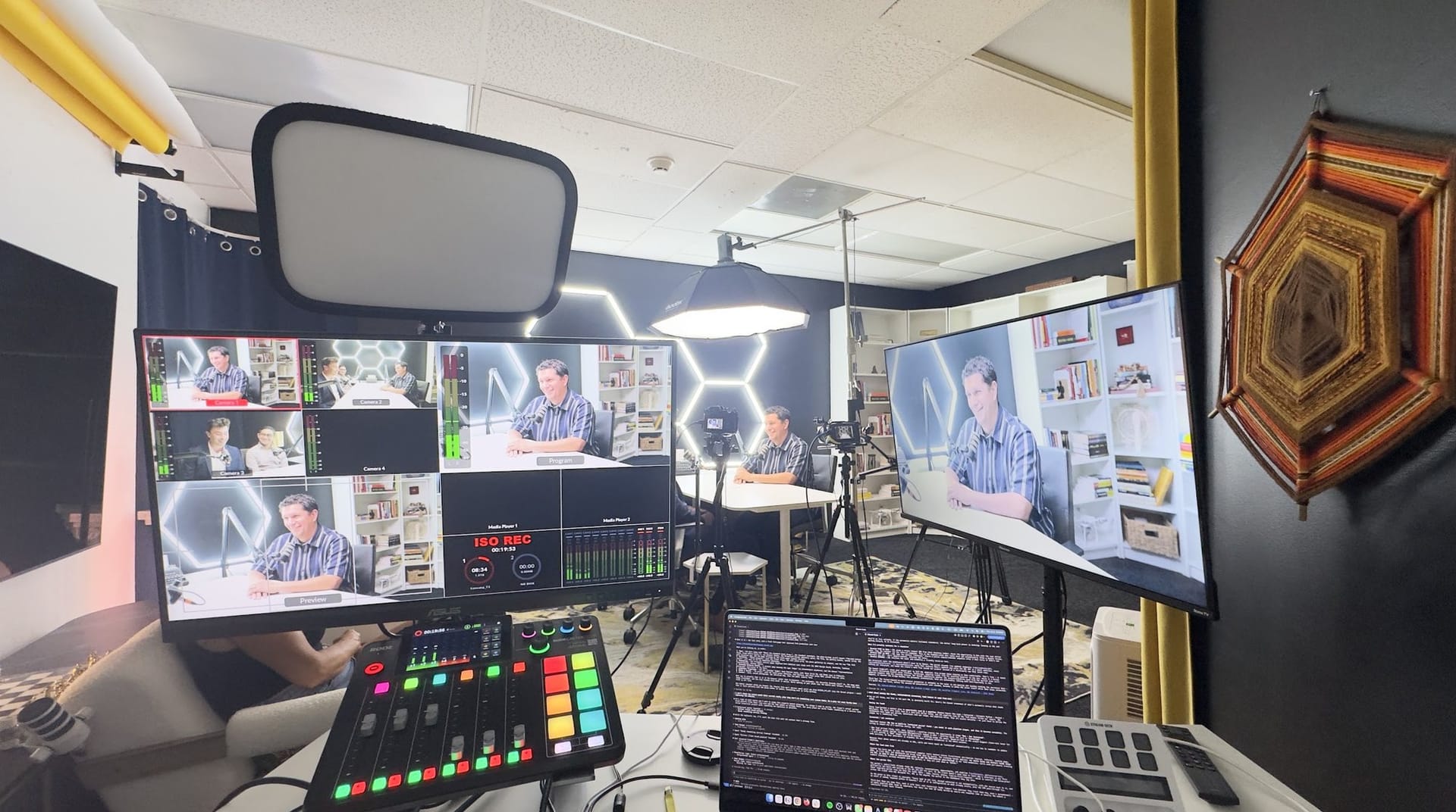 Production control desk with multiview monitors and a vision mixer in a dark room